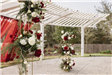 A Red Curtain and Flowers Decorate the Pergola